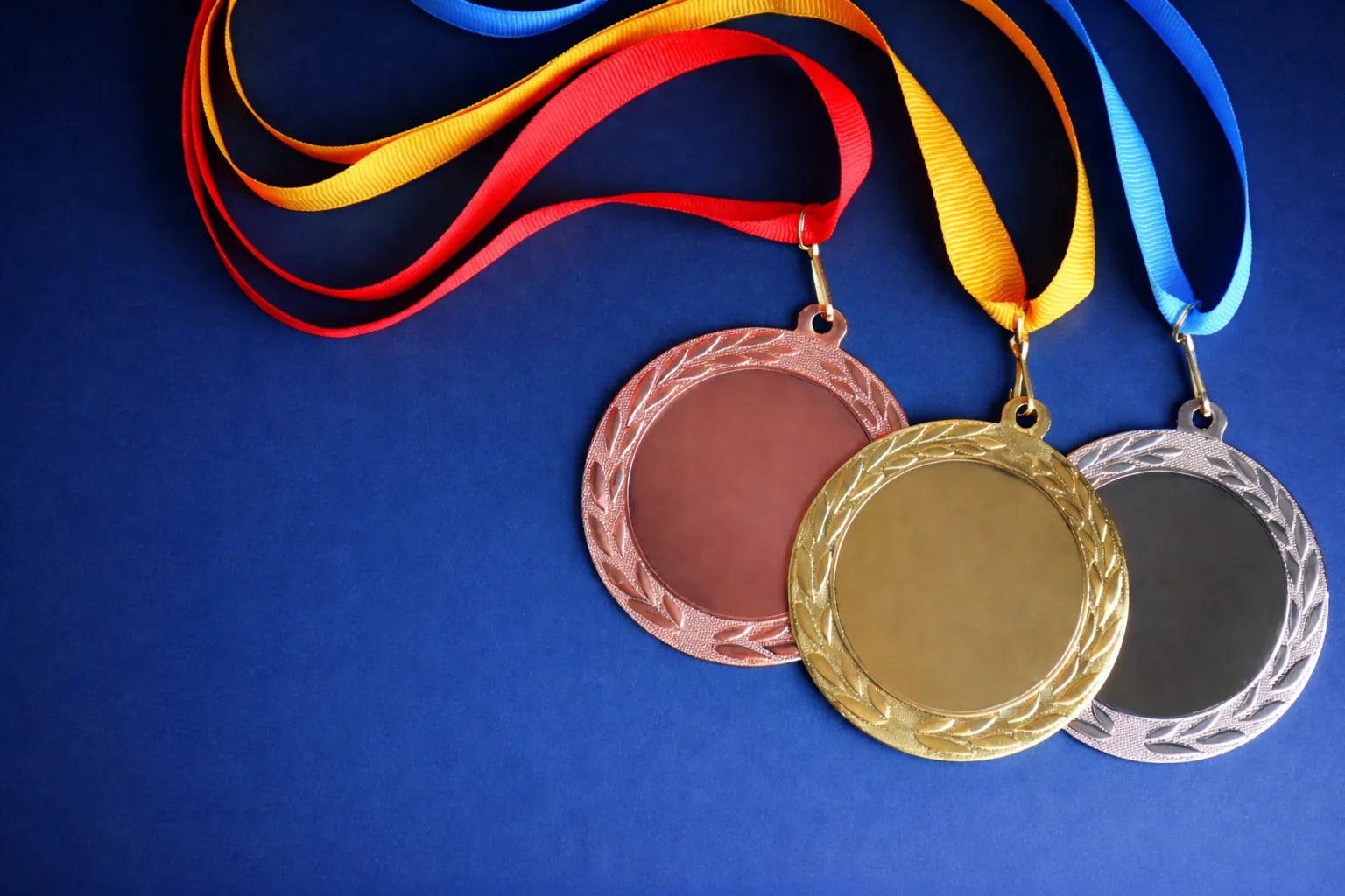 Gold, silver and bronze medals on a blue background